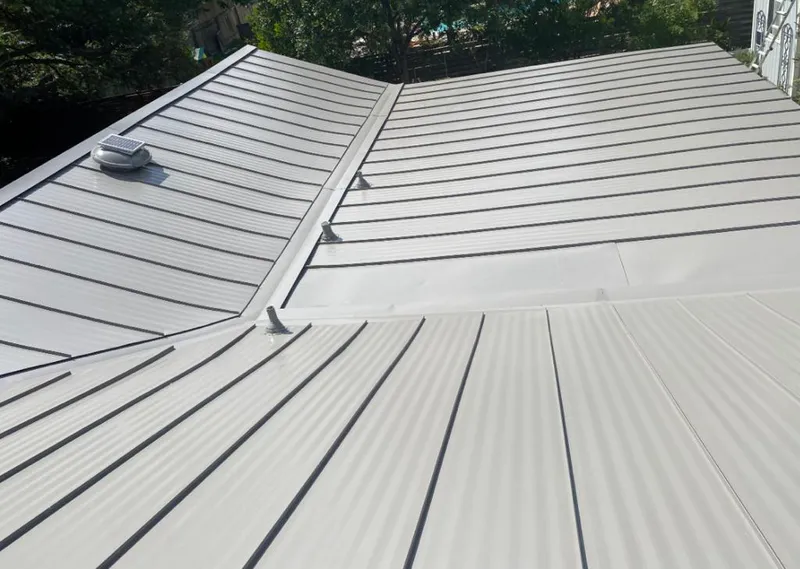 Solar attic fan installed on a metal roof for Roof Ventilation in Mason City